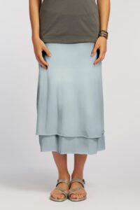 A woman wearing a long skirt in summer blue.