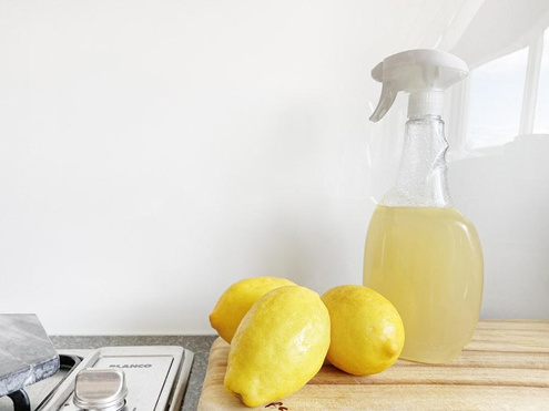 Lemons and homemade lemon cleaner bottle